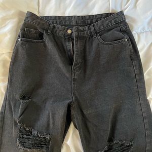 Black ripped jeans, straight/wide leg.